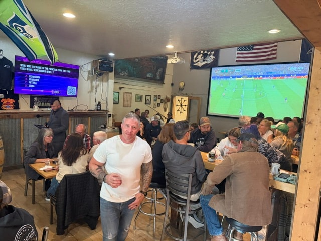 Taproom full of guests watching sports